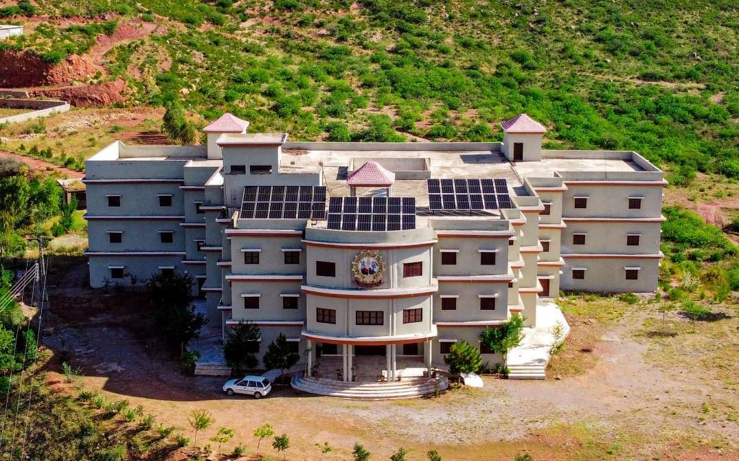 Aerial view of the Al-Asar Degree College building among the green hills of Usterzai Payan